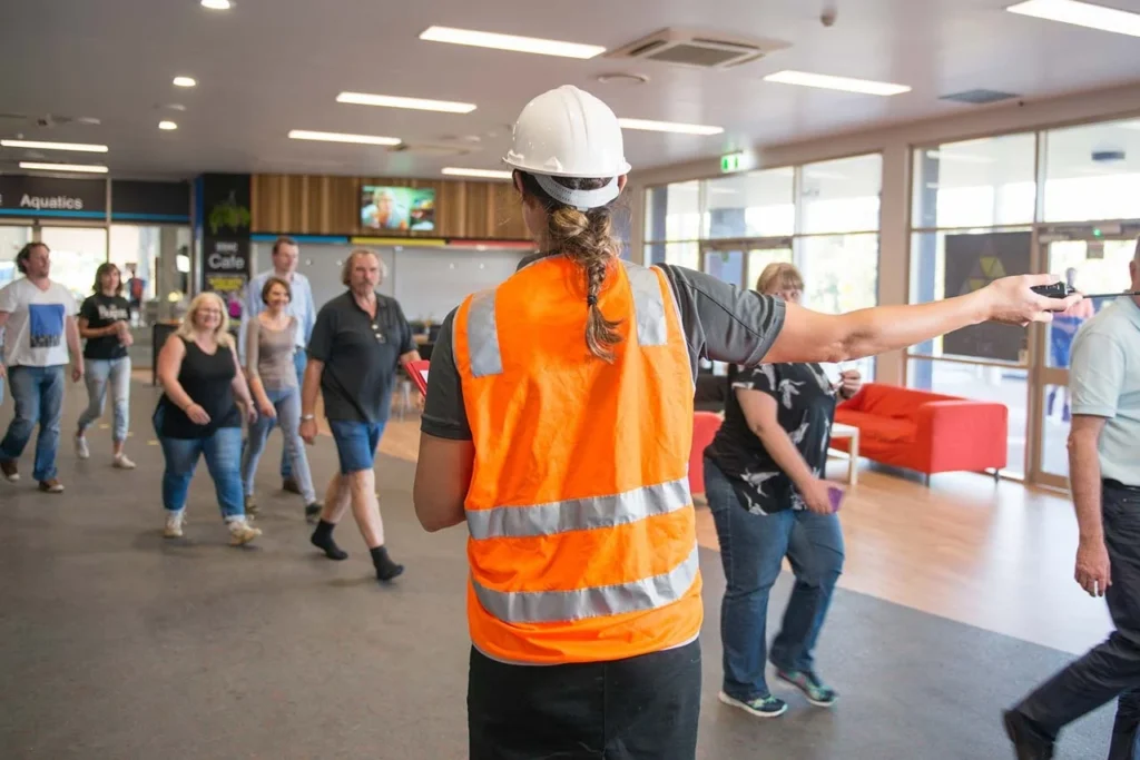 Safety officer guiding people during evacuation